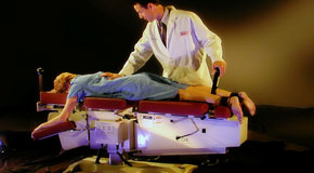 This is a picture of Cox Technic chiropratic spinal manipulation as performed at Aurora Chiropractic Center.